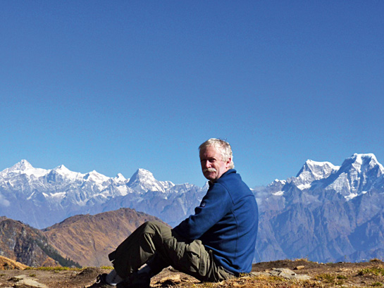 The author sits at the highest point on the Curzon trail, drinking in the spectacular view that the Kuari Pass offers.